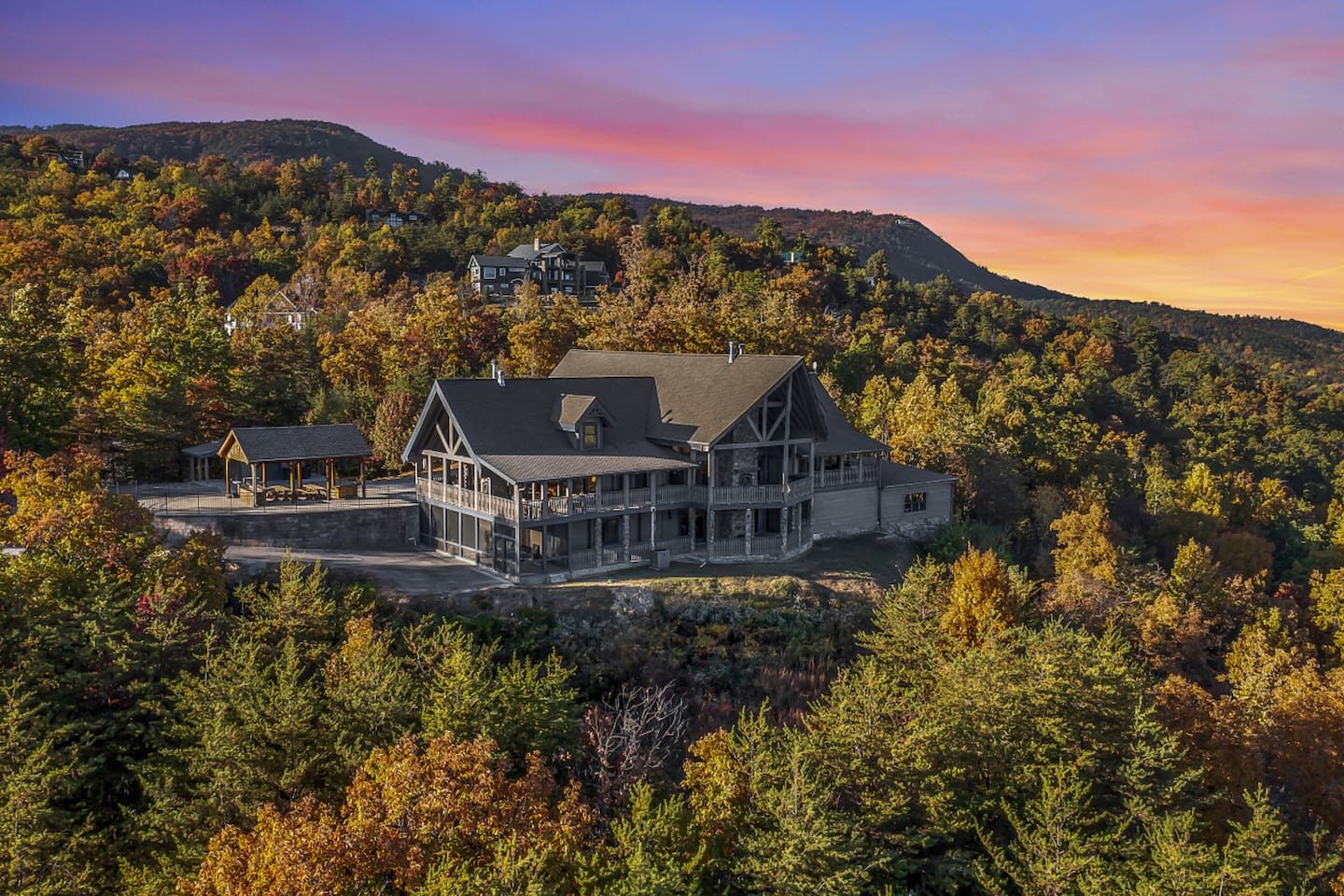 Sunset paints the ridges pink behind the lodge, and the lights come on in a welcoming glow. This is the view you'll dream about.