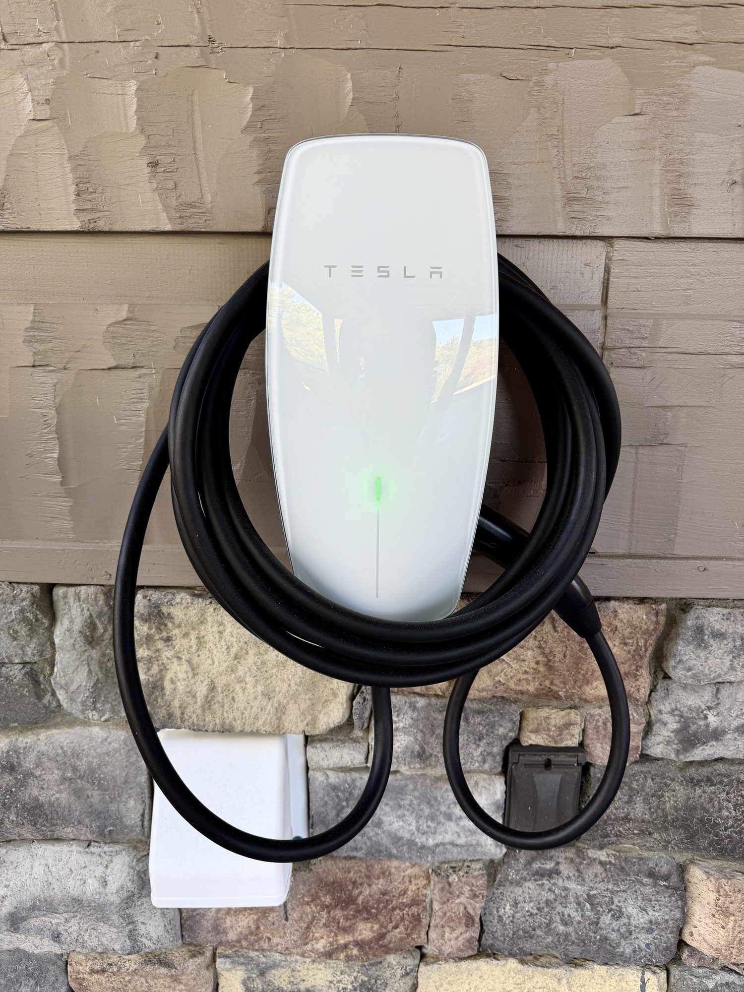 Arrive with a charge and leave with a full heart. Our Tesla Wall Connector is ready at the parking area; non-Tesla EVs need their own J1772 adapter.