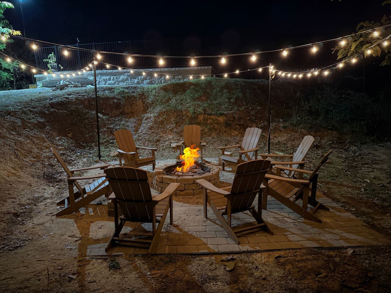 As the sun slips away, string lights twinkle above the fire pit. Gather the Adirondack chairs, roast marshmallows and trade stories under the stars.