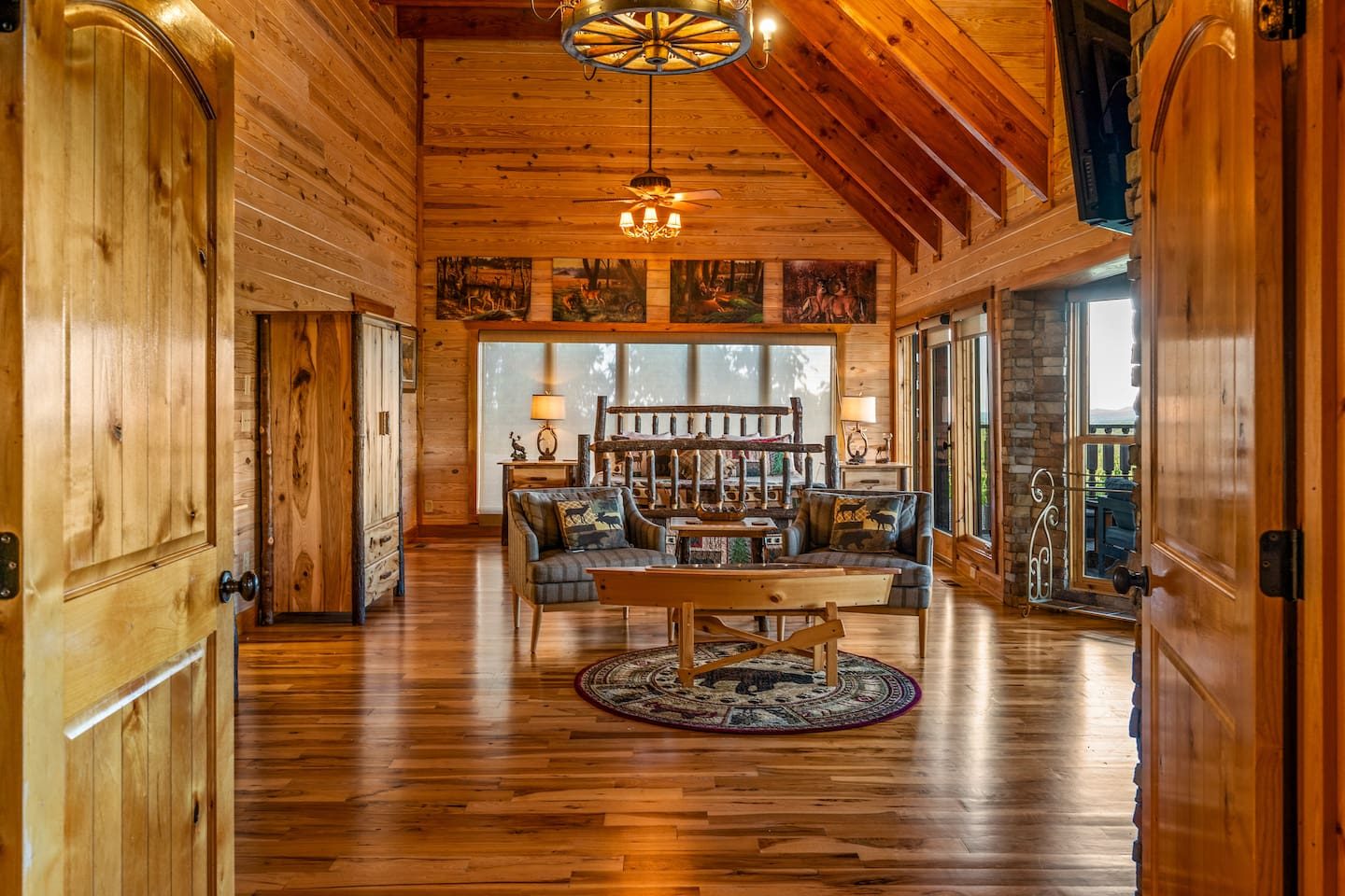 Wake up in your own sanctuary: a log-framed king bed, warm wood walls and a sitting area made for slow, quiet mornings.