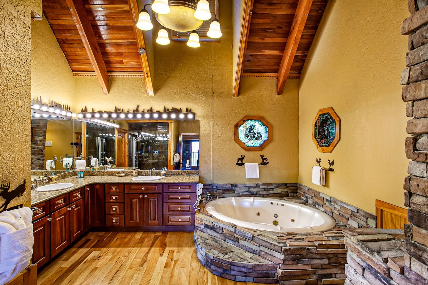Sink into the soaking tub beneath vaulted wood ceilings, with a double vanity nearby. A spa-style escape that makes a getaway feel like indulgence.