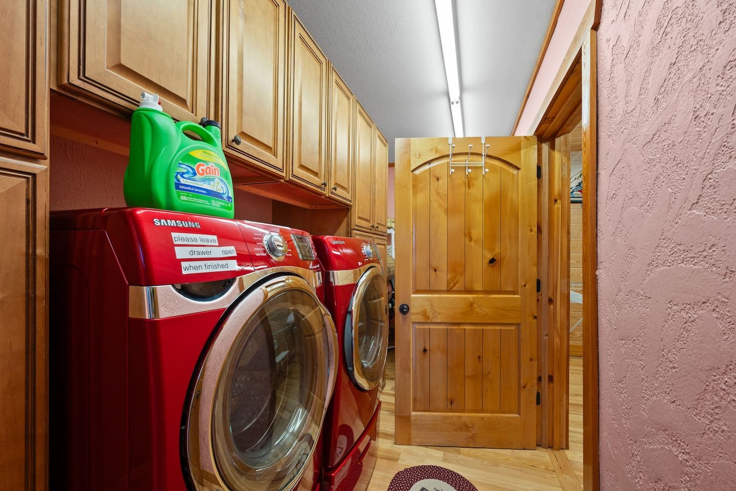 A red washer and dryer and plenty of cabinet space make clean-up easy. More time for the pool, less time for laundry.