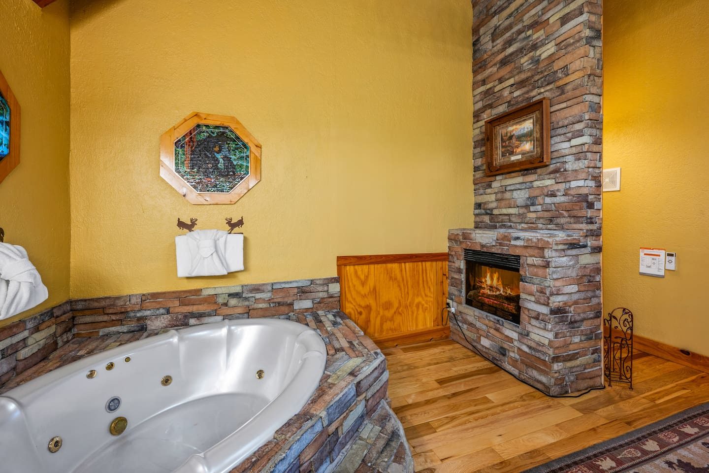 Calm? Just add bubbles. A stone-wrapped soaking tub beside a fireplace makes this primary bath the ultimate unwind.