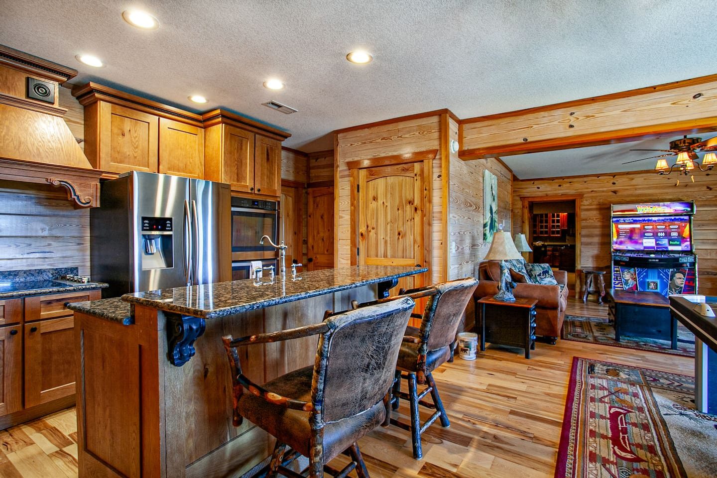 A kitchenette with a granite bar and stools right by the arcade room, so snacks, sips and high scores are never far apart.