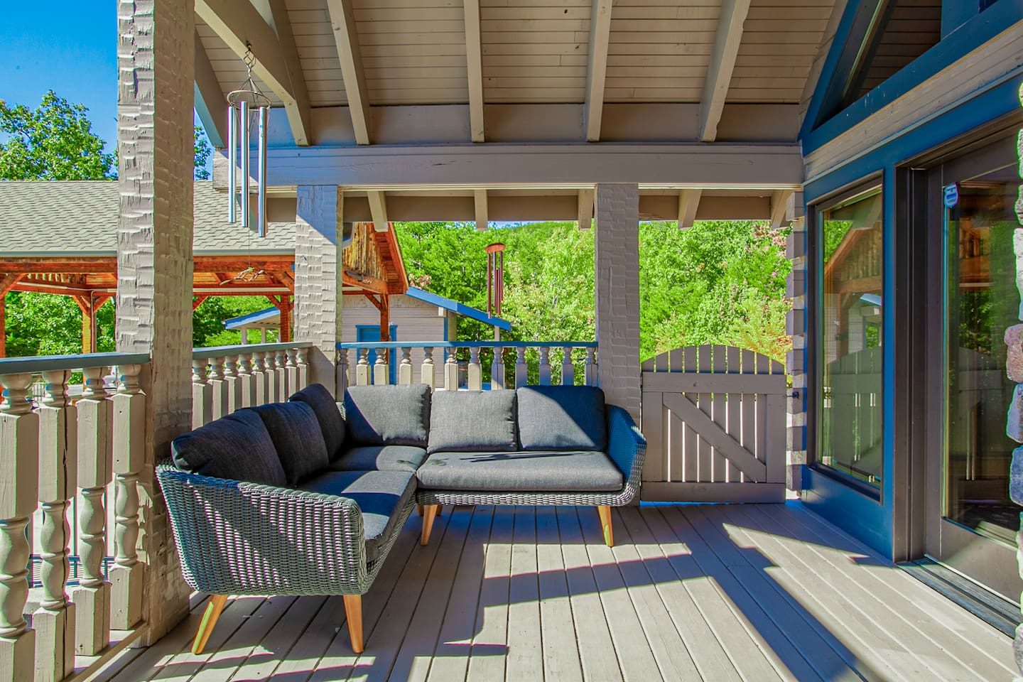 A shaded porch with plush outdoor sofas, tucked among the treetops. A quiet spot for a book, a nap or a good long talk.