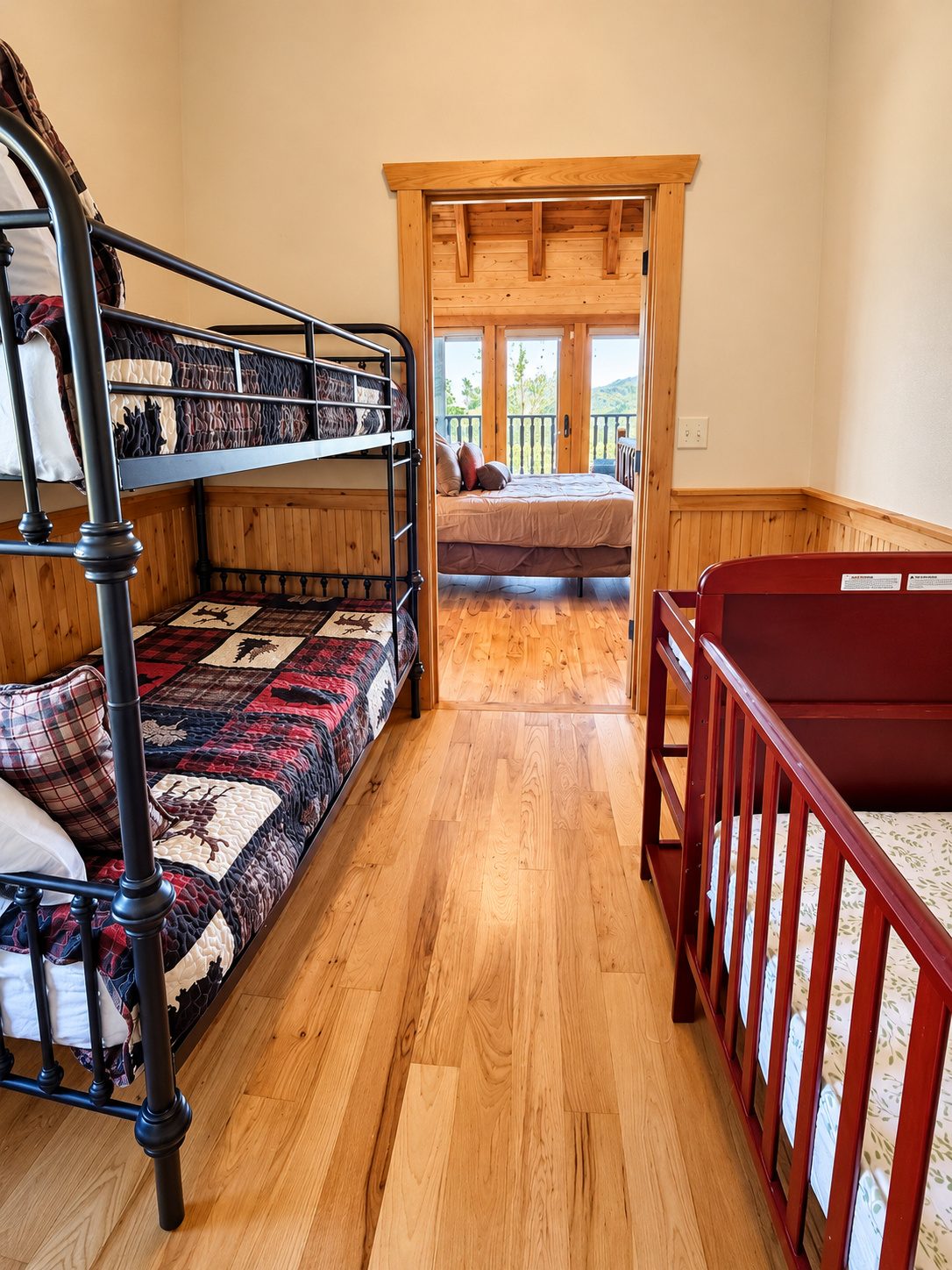Bunk beds dressed in plaid and a little crib. Everyone, from tiny to tall, has a cozy place to rest.